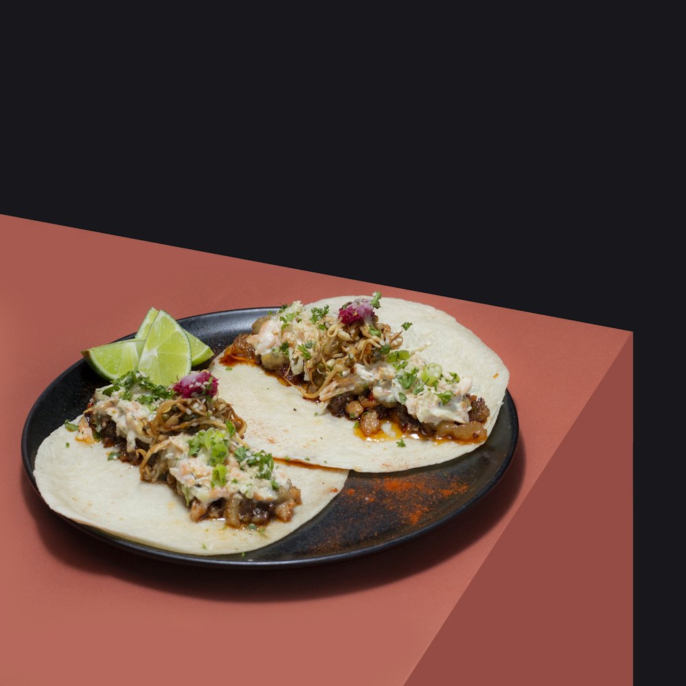 Stock photo of two tacos with lime